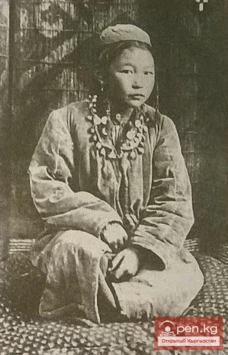 A 10-year-old girl in traditional costume. The first third of the 20th century. Kyrgyzstan