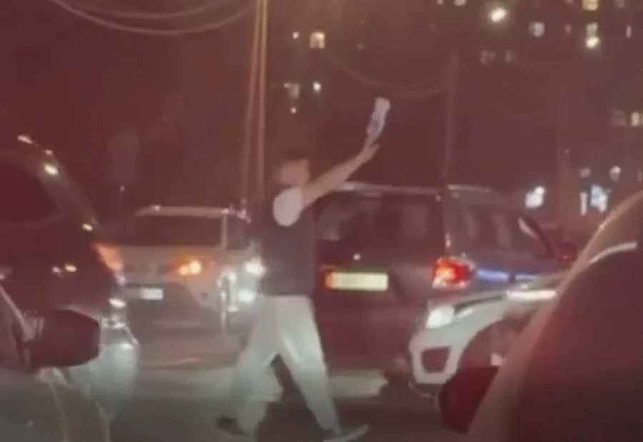 In Bishkek, a volunteer directed traffic with a whistle and a bottle